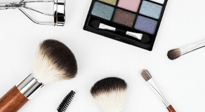 Makeup brushes, mascara brush and colour palette to illustrate how to remove a makeup stain from clothing