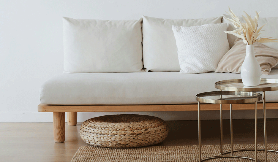 Living room with a white sofa, beige rug, and coffee tables to illustrate how to remove stains from home textiles: sofas, armchairs, rugs, tablecloths, and more 