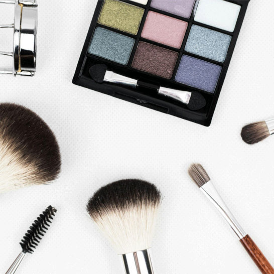 Makeup brushes, mascara brush and colour palette to illustrate how to remove a makeup stain from clothing